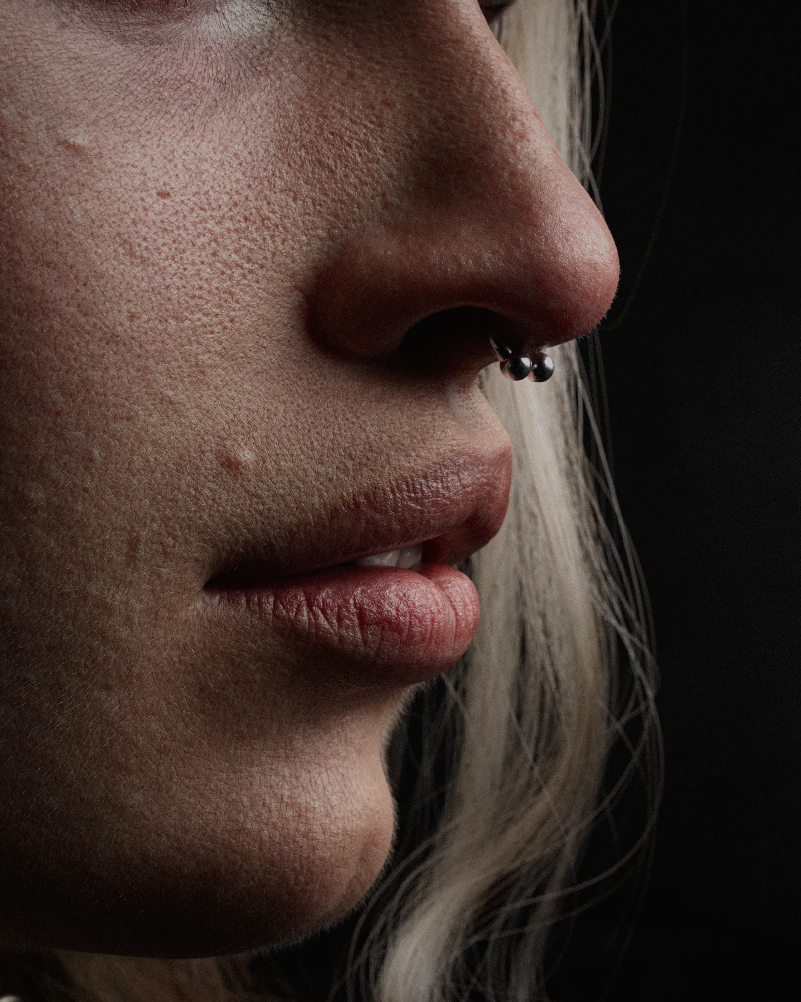 Extreme close-up of the 3D character's nose, lips and silver septum ring, showing pore-level skin detail
