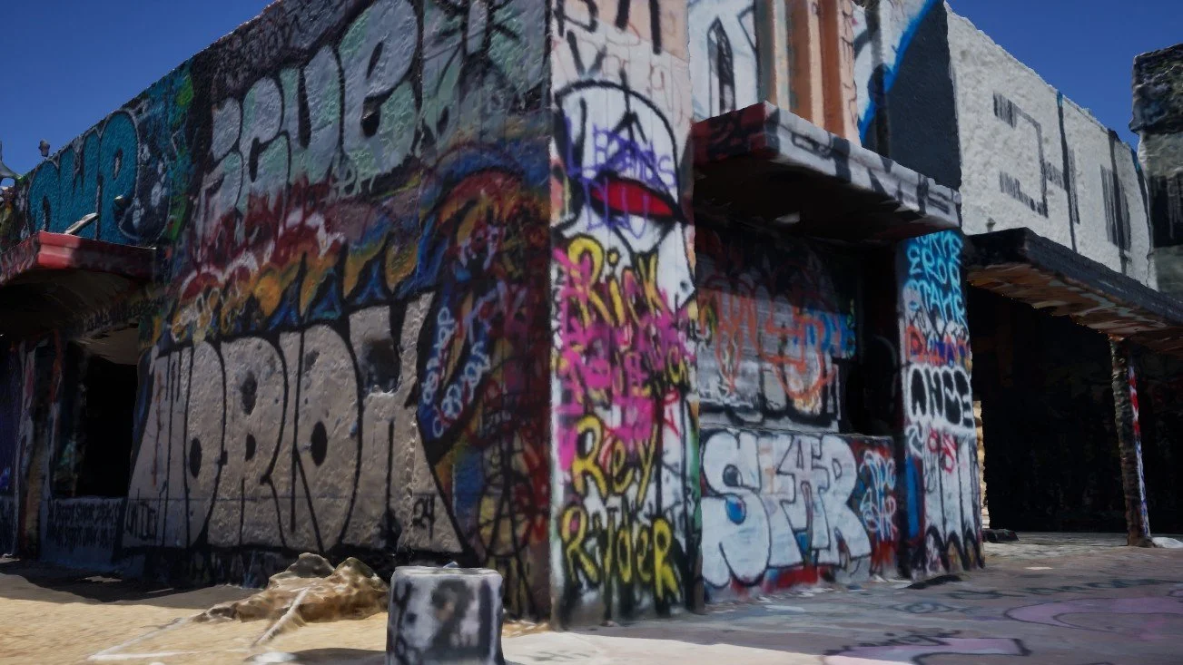 Close-up 3D render of a corner of the scanned graffiti building with block-letter tags and a short concrete post in front